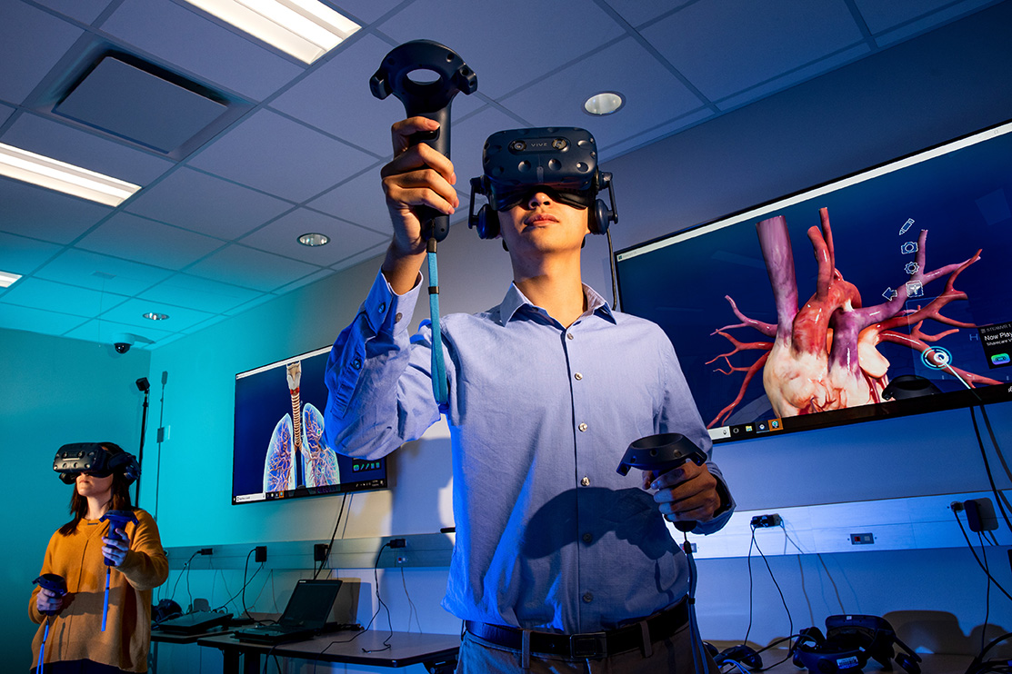 Student using a VR headset and hand controls